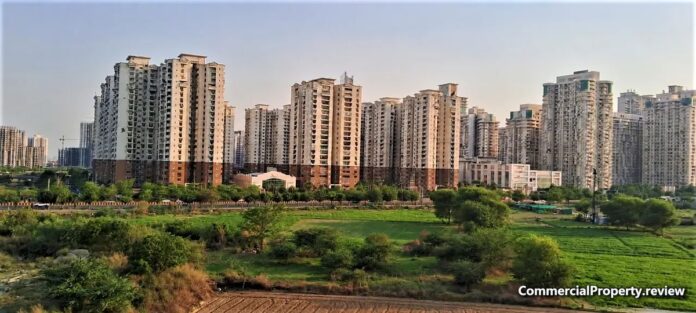 Residential high-rise societies behind green open land in Central Noida
