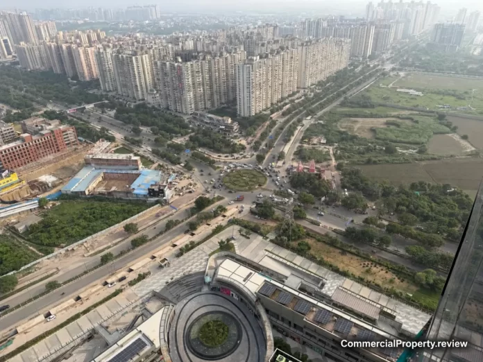 Aerial view of residential towers, roads and a roundabout in Greater Noida West